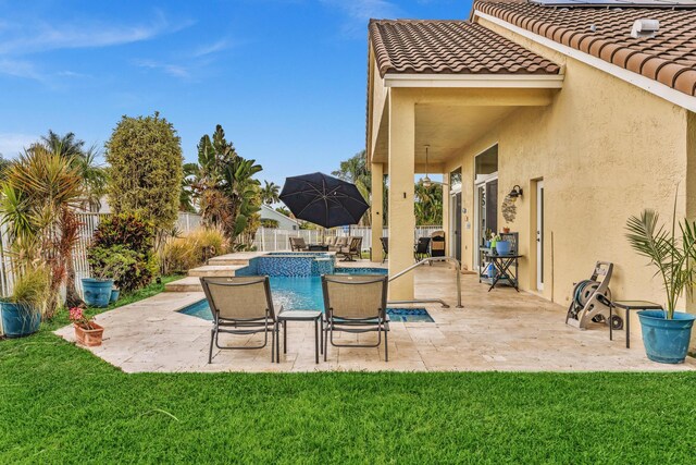 view of patio / terrace featuring a fenced backyard and a pool with connected hot tub