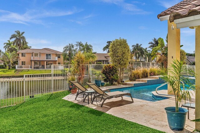 view of swimming pool with a fenced backyard, a fenced in pool, a yard, and a patio area