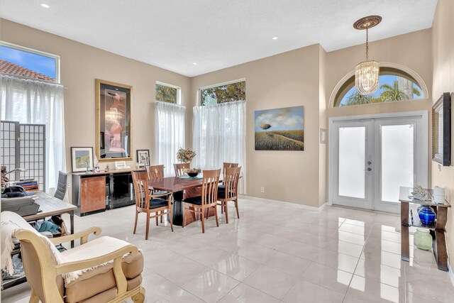 dining area with an inviting chandelier, light tile patterned flooring, baseboards, recessed lighting, and french doors