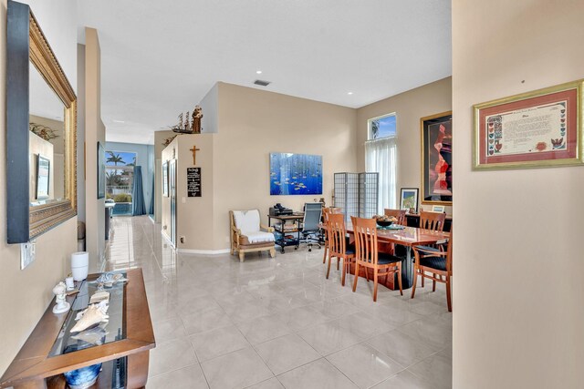 dining space featuring baseboards and light tile patterned floors