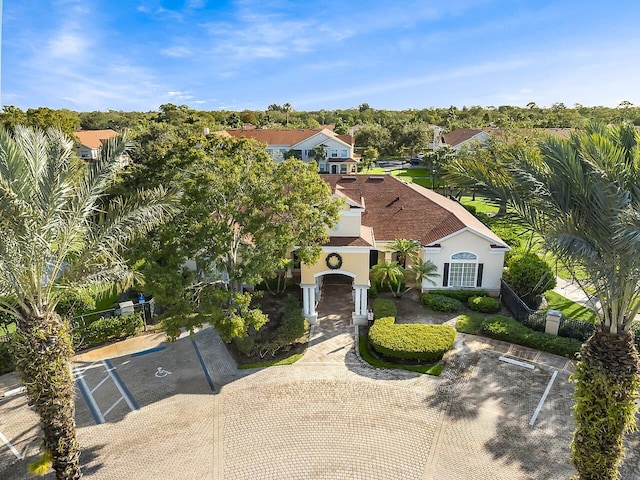 view of front of home with uncovered parking and stucco siding