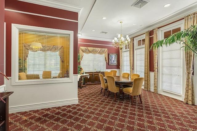 dining room with carpet flooring, a notable chandelier, ornamental molding, and visible vents