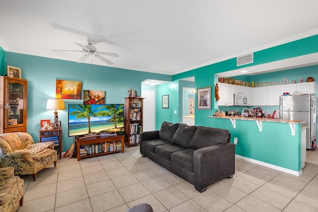 living area with visible vents, ornamental molding, and light tile patterned floors