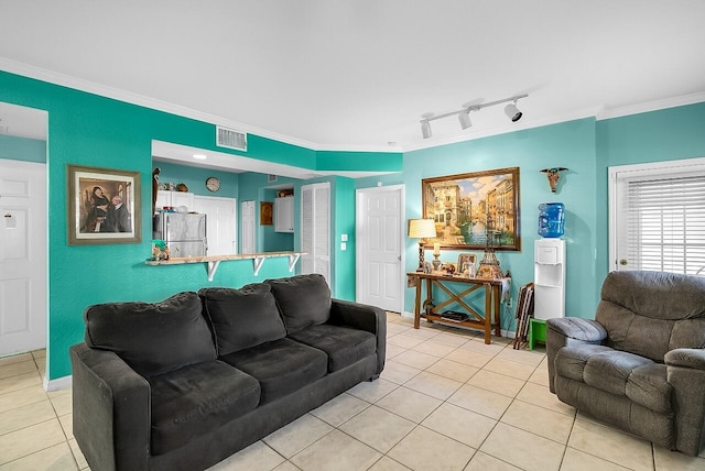 living area with crown molding, baseboards, light tile patterned flooring, and visible vents