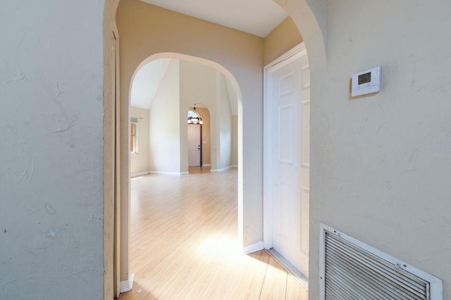 2650 SW Acco Rd, Port Saint Lucie, FL 34953 - hallway featuring arched walkways and light wood-style flooring