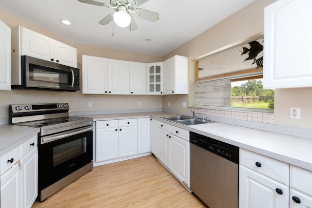 2650 SW Acco Rd, Port Saint Lucie, FL 34953 - kitchen with appliances with stainless steel finishes, a sink, light countertops, white cabinetry, and recessed lighting