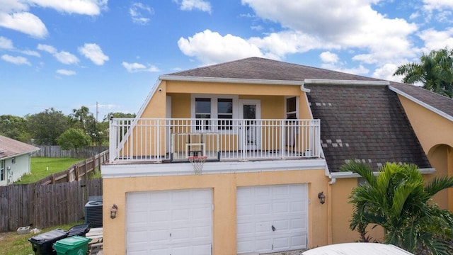 2650 SW Acco Rd, Port Saint Lucie, FL 34953 - view of front facade featuring a garage, stucco siding, roof with shingles, and a balcony