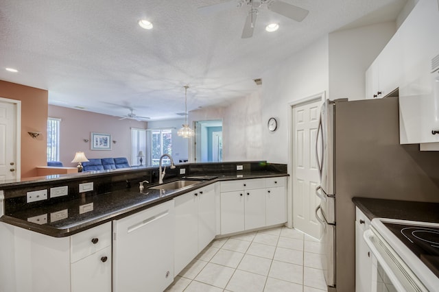 606 SW Treasure Cv, Port Saint Lucie, FL 34986 - kitchen featuring white dishwasher, a sink, ceiling fan, open floor plan, and a peninsula