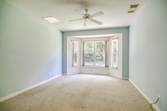 606 SW Treasure Cv, Port Saint Lucie, FL 34986 - carpeted empty room featuring a ceiling fan, baseboards, and a textured ceiling