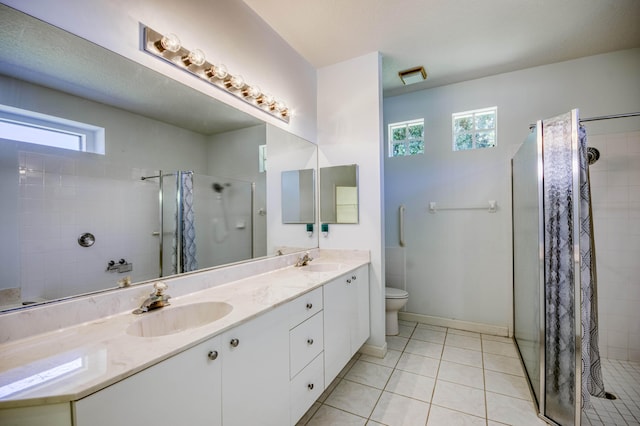 606 SW Treasure Cv, Port Saint Lucie, FL 34986 - full bathroom with a stall shower, tile patterned floors, double vanity, toilet, and baseboards