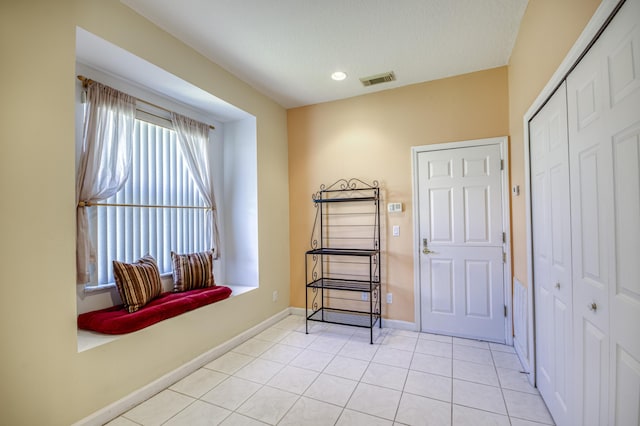 606 SW Treasure Cv, Port Saint Lucie, FL 34986 - living area featuring light tile patterned floors and baseboards