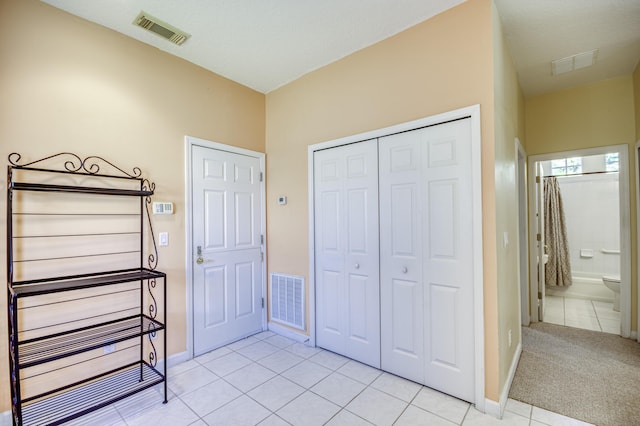 606 SW Treasure Cv, Port Saint Lucie, FL 34986 - bedroom featuring light tile patterned floors, a closet, and baseboards