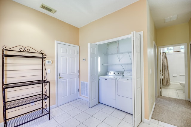 606 SW Treasure Cv, Port Saint Lucie, FL 34986 - clothes washing area with separate washer and dryer, light tile patterned floors, and baseboards