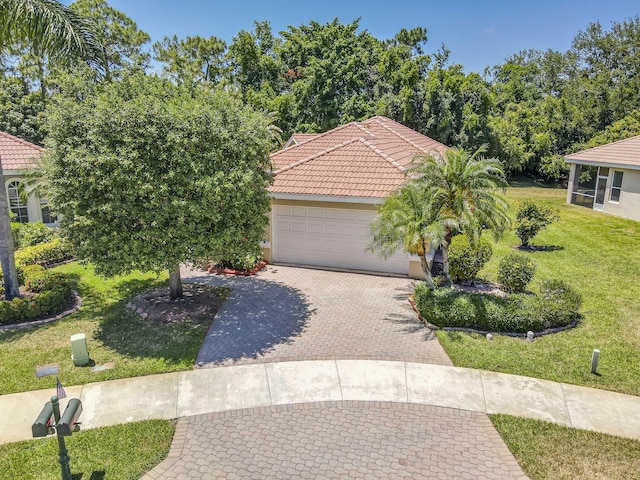 606 SW Treasure Cv, Port Saint Lucie, FL 34986 - mediterranean / spanish-style home with a tiled roof, a front lawn, an attached garage, decorative driveway, and stucco siding