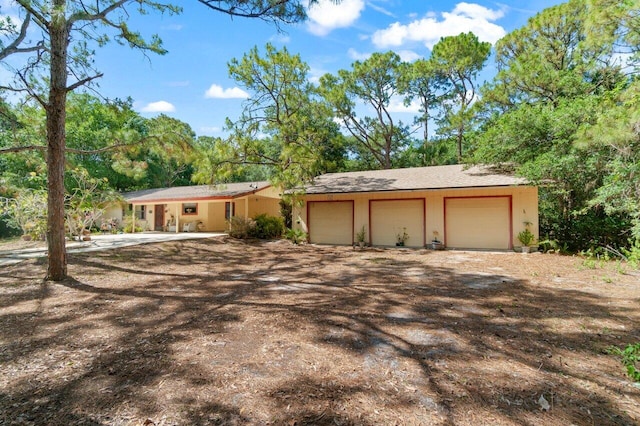 ranch-style house featuring a detached garage