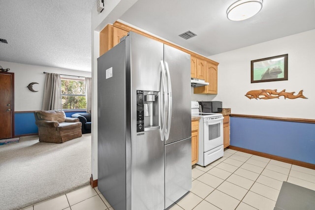 kitchen featuring white electric range oven, stainless steel fridge, open floor plan, under cabinet range hood, and visible vents