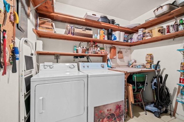 clothes washing area with washing machine and clothes dryer, laundry area, and tile patterned floors