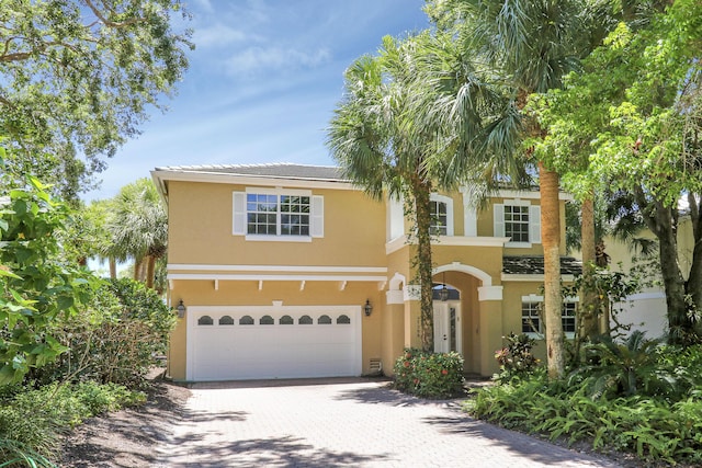17288 Shoals Dr, Jupiter, FL 33477 - view of front of property with a garage, stucco siding, and driveway