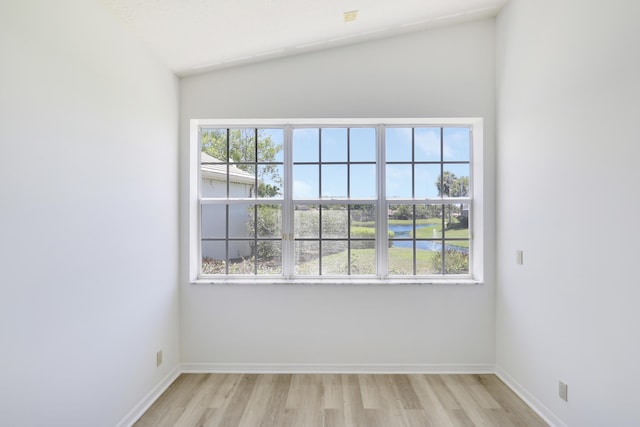 17288 Shoals Dr, Jupiter, FL 33477 - spare room with light wood-style floors, plenty of natural light, a water view, and vaulted ceiling