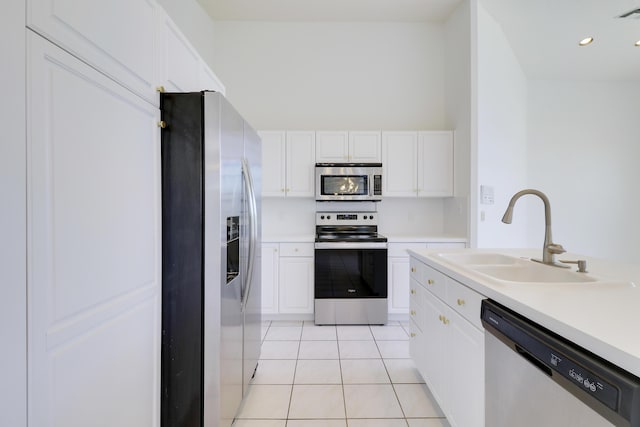 17288 Shoals Dr, Jupiter, FL 33477 - kitchen with appliances with stainless steel finishes, light tile patterned floors, white cabinets, light countertops, and recessed lighting