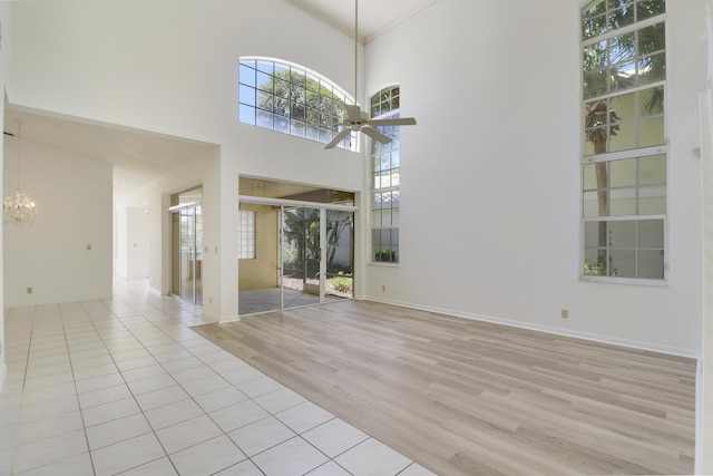 17288 Shoals Dr, Jupiter, FL 33477 - spare room with ceiling fan, light wood-type flooring, and a towering ceiling