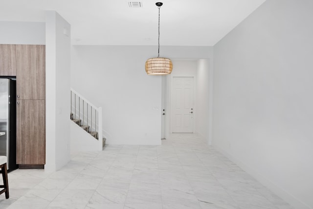 hall featuring visible vents, marble finish floor, and stairway