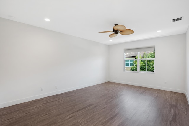 spare room with visible vents, baseboards, ceiling fan, and wood finished floors