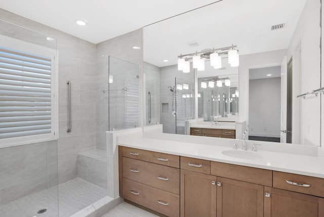 bathroom featuring visible vents, vanity, and a shower stall