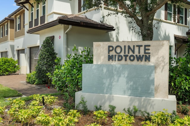 community / neighborhood sign with an attached garage