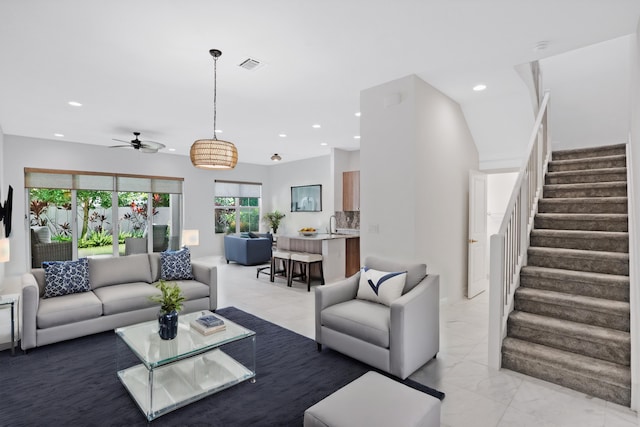 living area featuring visible vents, marble finish floor, ceiling fan, stairway, and recessed lighting