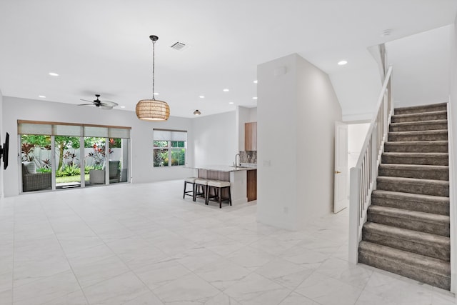 interior space with recessed lighting, marble finish floor, ceiling fan, and visible vents