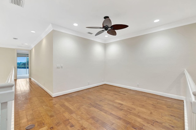 spare room featuring ceiling fan, light wood finished floors, and visible vents