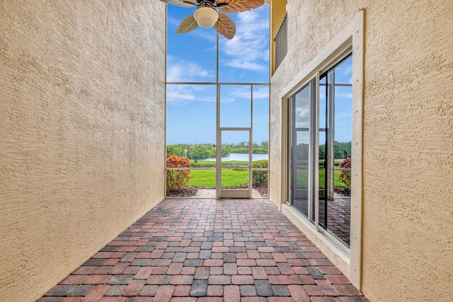 unfurnished sunroom featuring a water view