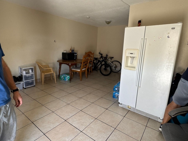 410 S F St, Lake Worth, FL 33460 - kitchen featuring white refrigerator with ice dispenser and light tile patterned flooring