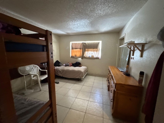 410 S F St, Lake Worth, FL 33460 - bedroom featuring a textured ceiling and light tile patterned flooring