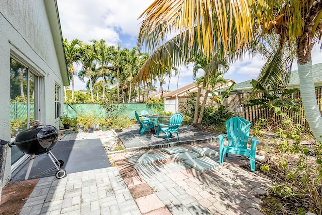 view of patio featuring a fenced backyard, outdoor dining space, and area for grilling