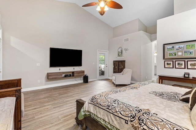 bedroom with high vaulted ceiling, baseboards, light wood-type flooring, and visible vents
