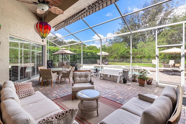 sunroom / solarium featuring ceiling fan, an outdoor living space, and outdoor dining space
