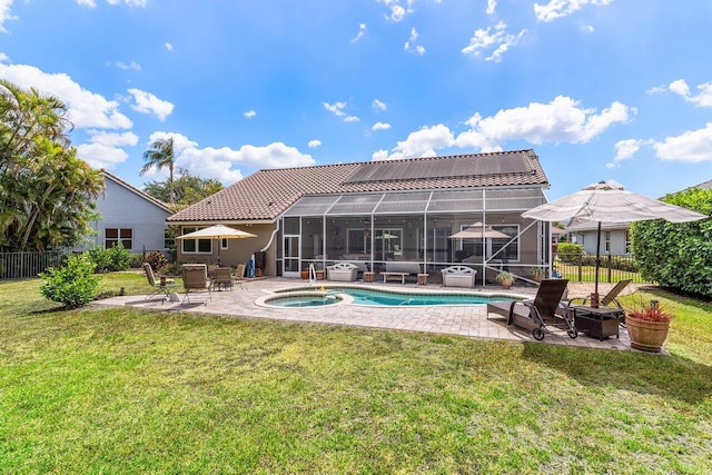 back of property with fence, an in ground hot tub, a patio area, a lanai, and a yard