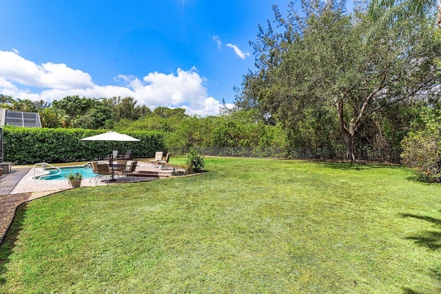 view of yard with a fenced in pool, a fenced backyard, and a patio area
