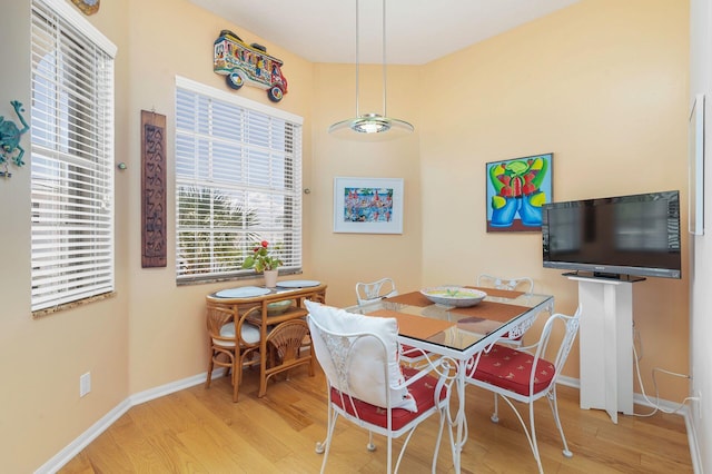 dining space featuring wood finished floors and baseboards