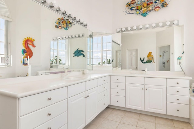 bathroom with tile patterned floors, a shower, and double vanity
