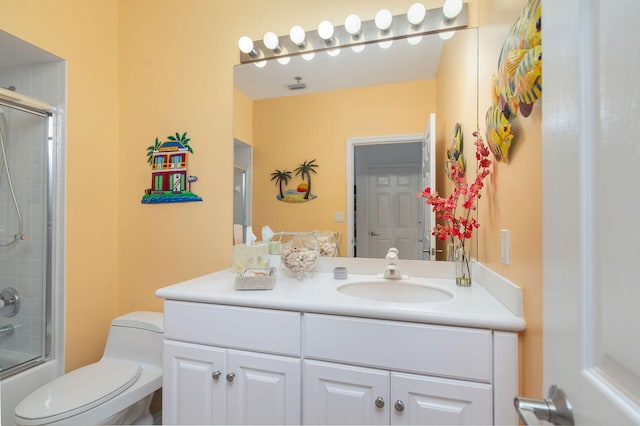 bathroom featuring toilet, vanity, and enclosed tub / shower combo