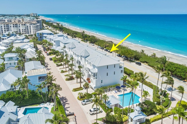 drone / aerial view of a pool area and unending shoreline
