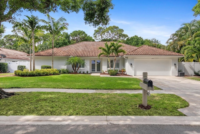view of front facade featuring a garage, a front lawn, fence, stucco siding, and a tile roof