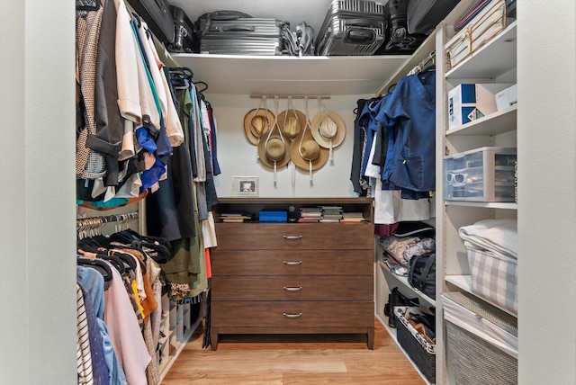 walk in closet with wood finished floors
