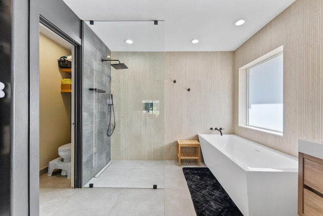 full bathroom featuring a walk in shower, a freestanding bath, toilet, tile patterned floors, and recessed lighting