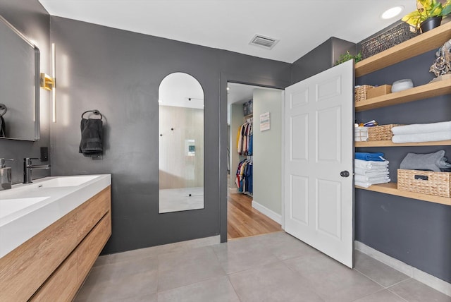 full bath featuring tile patterned floors, vanity, and visible vents