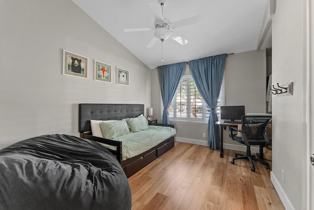 bedroom with baseboards, ceiling fan, vaulted ceiling, and wood finished floors