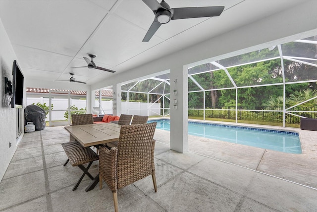 view of swimming pool with ceiling fan, a fenced in pool, a patio area, glass enclosure, and fence private yard